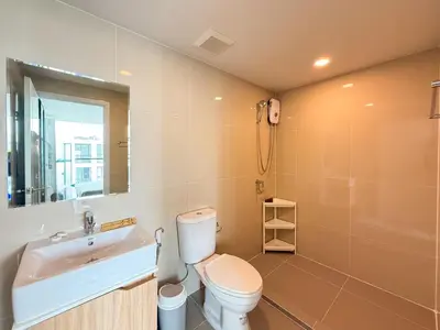 a bathroom with a toilet and a sink and a shower at Near BTS - Near Iconsiam - Pool and Gym - Sontana in Bangkok