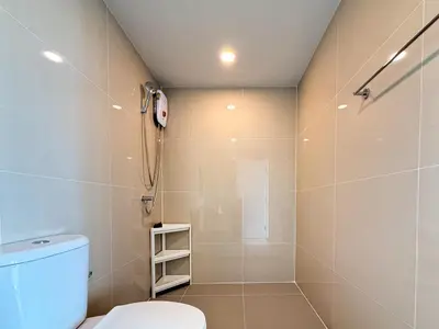 a bathroom with a shower and a toilet at Near BTS - Near Iconsiam - Pool and Gym - Sontana in Bangkok