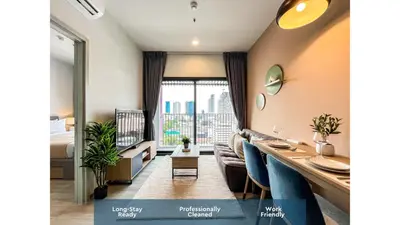 a living room with a couch and a dining table at Near BTS l Fully Furnished l Pool and Gym l Sontana in Bangkok