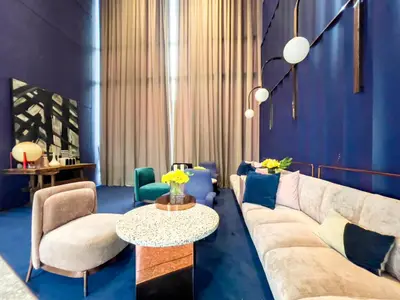a living room with a couch and chairs and a table at Near BTS l Fully Furnished l Pool and Gym l Sontana in Bangkok
