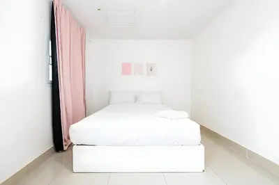 a small white room with two beds in it at XX Oh My Nap - Sukhumvit 3 - โอ้มายแนป สุขุมวิท 3 in Makkasan