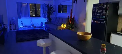 a kitchen and living room at night with a couch at Newly renovated 1 bedroom condo NANA in Bang Kapi