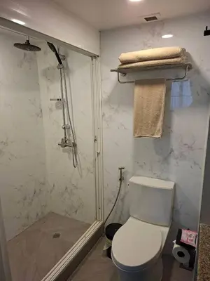 a bathroom with a shower and a toilet and a shower at Newly renovated 1 bedroom condo NANA in Bang Kapi