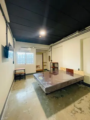 a large empty room with a bed in it at Fit mansion in Sathani Sam Sen