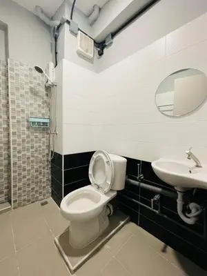 a bathroom with a toilet and a sink at Fit mansion in Sathani Sam Sen