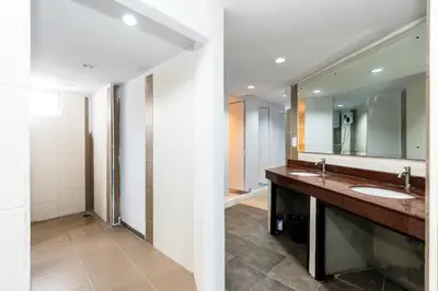 a bathroom with two sinks and a large mirror at XX The Hidden Khaosan - เดอะ ฮิดเด้น ถนนข้าวสาร in Bang Bua Thong Railway Station