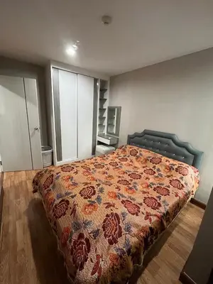 a bedroom with a bed with a floral bedspread at AC Home 2 Laksi in Lak Si