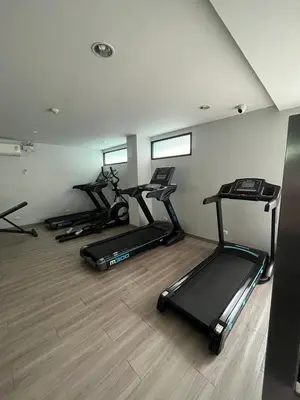 a gym with three exercise bikes in a room at AC Home 2 Laksi in Lak Si