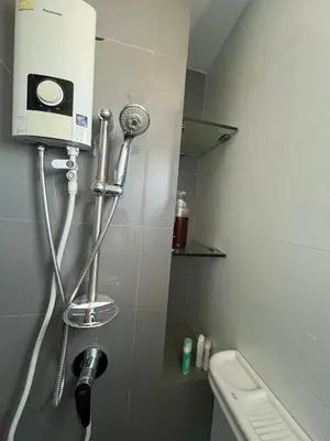 a bathroom with a toilet and a hair dryer at AC Home 2 Laksi in Lak Si