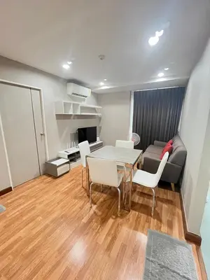 a living room with a table and a couch at AC Home 2 Laksi in Lak Si