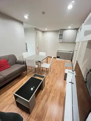 a living room with a couch and a table at AC Home 2 Laksi in Lak Si