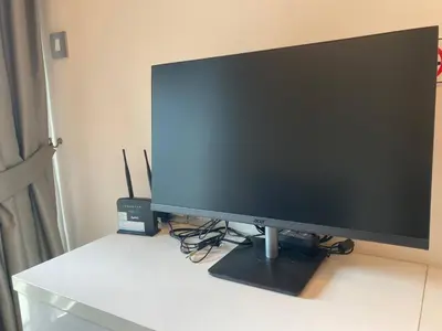 a computer monitor sitting on top of a desk at Free Airport Pick Up Rooftop Pool Gym near BTS Emquartier Shopping city center in Bangkok