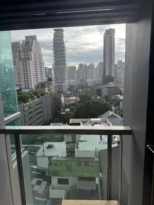 a view of a city skyline from a window at Free Airport Pick Up Rooftop Pool Gym near BTS Emquartier Shopping city center in Bangkok
