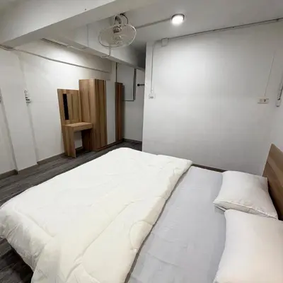 a bedroom with a large white bed with two pillows at Box me in Bangkok