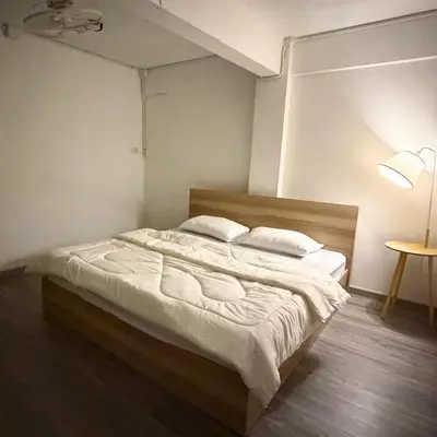 a bedroom with a bed with white sheets and pillows at Box me in Bangkok
