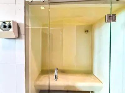 a shower with a glass door in a bathroom at BTS Thong Lol Large 52 sqm l Pool and Gym l Sontana in Bangkok