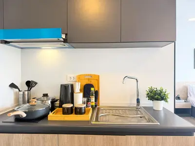 a kitchen with a sink and a counter top at Near BTS - Near Iconsiam - Pool and Gym - Sontana in Bangkok