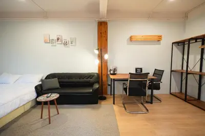 a bedroom with a couch and a table and a bed at Dec room at bangsue in Bang Su