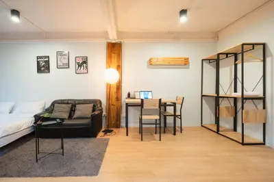 a room with a bed and a table and a couch at Dec room at bangsue in Bang Su