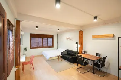 a living room with a bed and a table at Dec room at bangsue in Bang Su
