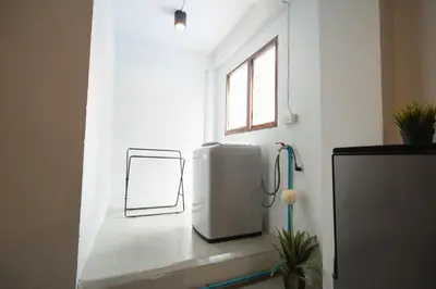 a bathroom with a water heater and a window at Dec room at bangsue in Bang Su