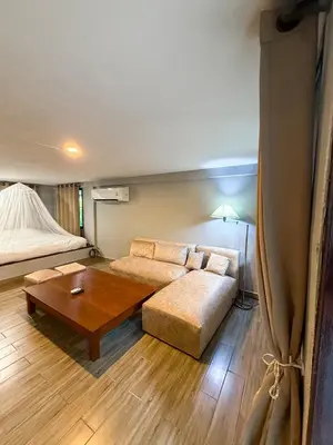 a living room with a couch and a coffee table at Pridi cozy home with good location Type A in Bangkok