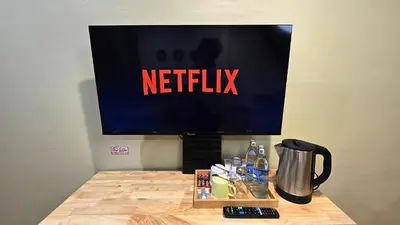 a television with a netflix sign on top of a table at Postel Chinatown in Bangkok