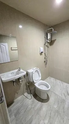 a bathroom with a toilet and a sink at Postel Chinatown in Bangkok