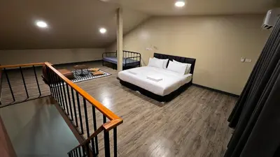 a bedroom with a bed and a stairway with a bed sqor at Postel Chinatown in Bangkok