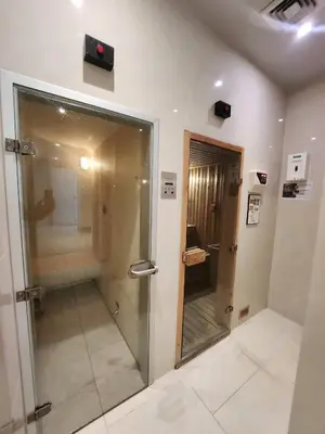 a bathroom with a walk in shower and a mirror at Prime 1BR in Sukhumvit 11 CentralStylishModern in Makkasan