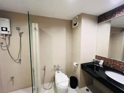 a bathroom with a shower and a toilet and a sink at 14 Place in Bangkok