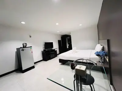 a hotel room with a bed and a glass table at 14 Place in Bangkok