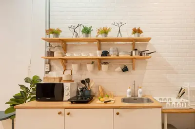 a kitchen with a counter with a microwave and a sink at Soulful Stay-Hidden Thai-Mediterranean Retreat. in Bangkok