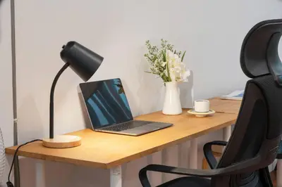 a laptop computer sitting on a desk with a lamp at Soulful Stay-Hidden Thai-Mediterranean Retreat. in Bangkok