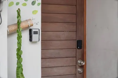 a wooden door with a handle on a wall at Soulful Stay-Hidden Thai-Mediterranean Retreat. in Bangkok