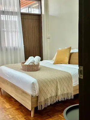 two beds in a room with a basket on the bed at Spacious 2BR2BA in Thonglor with WiFi & balcony in Khlong Toei