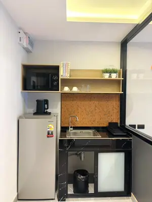 a small kitchen with a sink and a refrigerator at J5 Hotel in Ban Zong Katiam