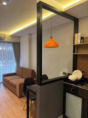 a living room with a couch and a mirror at J5 Hotel in Ban Zong Katiam