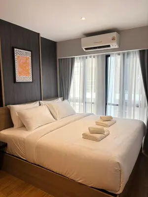 a bedroom with a large bed with towels on it at J5 Hotel in Ban Zong Katiam
