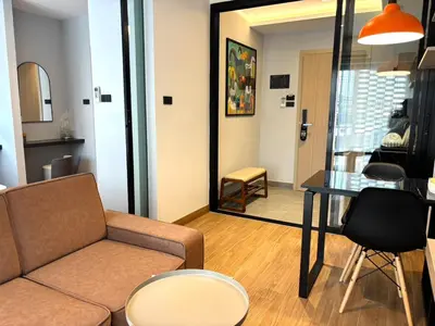 a living room with a couch and a table at J5 Hotel in Ban Zong Katiam