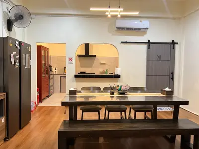 a kitchen with a table and chairs in a room at Baan29 in Bangkok