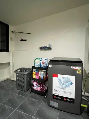 a kitchen with a trash can next to a trash can at Baan29 in Bangkok