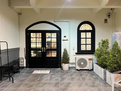 a room with a black door and some plants at Baan29 in Bangkok