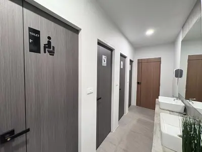 a bathroom with a toilet and a sink at City Pause Hostel in Sathani Bang Su