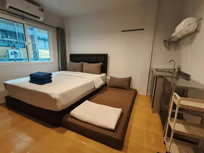 a bedroom with a large bed and a window at D45 Home - BTS Ratchathewi N1 Station in Bangkok