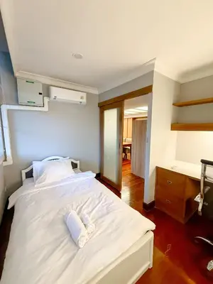 a bedroom with a white bed with two towels on it at Pridi cozy home with good location Type C in Bangkok