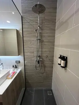 a bathroom with a shower and a sink at BubbleHumbleBangkok in Bangkok