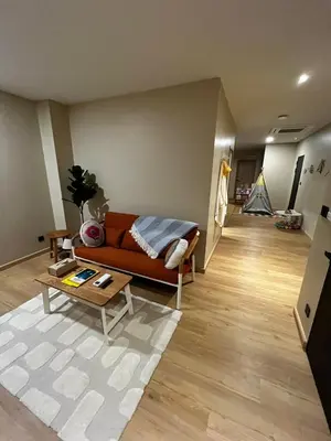 a living room with a couch and a table at BubbleHumbleBangkok in Bangkok