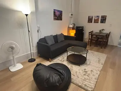 a living room with a couch and a table at Siam Central 2BR Yumi house Near IconSiam in Bangkok