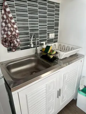 a kitchen counter with a sink in a kitchen at Free Wi-Fi Private Room I Near the Mall Bangkapi in Bangkok